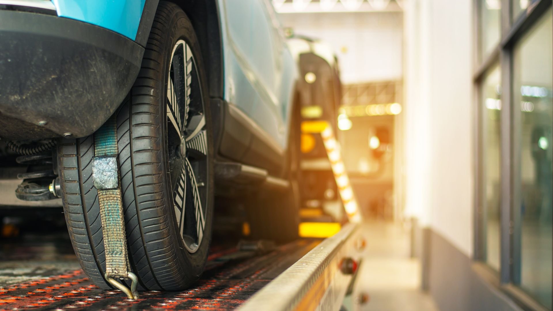 Car tire on platform with blurry automotive service center background