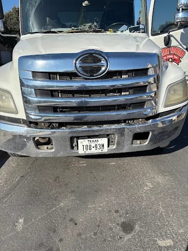 White commercial truck with chrome grille and Texas license plate